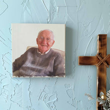 Load image into Gallery viewer, Custom art canvas wrap depicting a deceased love one grandparent grandfather made from a person photo and hung on a wall by a wooden cross
